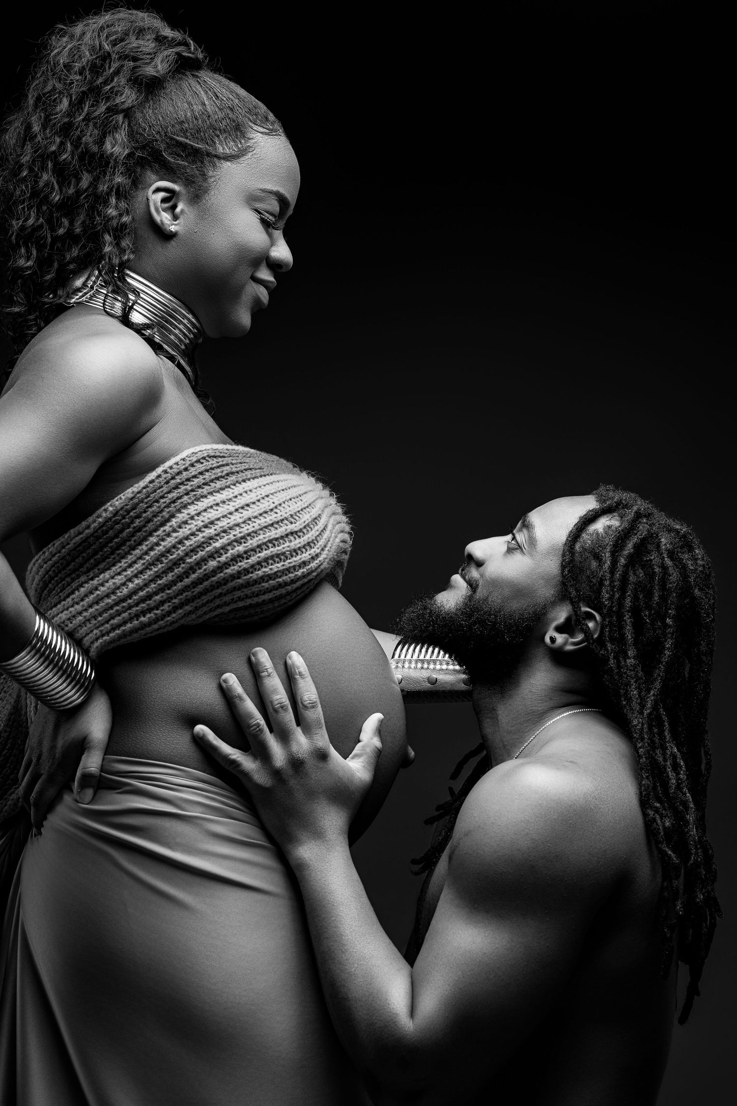 A tender black and white maternity photoshoot sequence showing intimate moments between an expectant couple.
