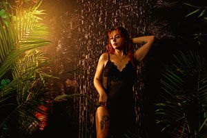 Dark and moody boudoir portrait with jungle elements captured in a Tilton NH studio.