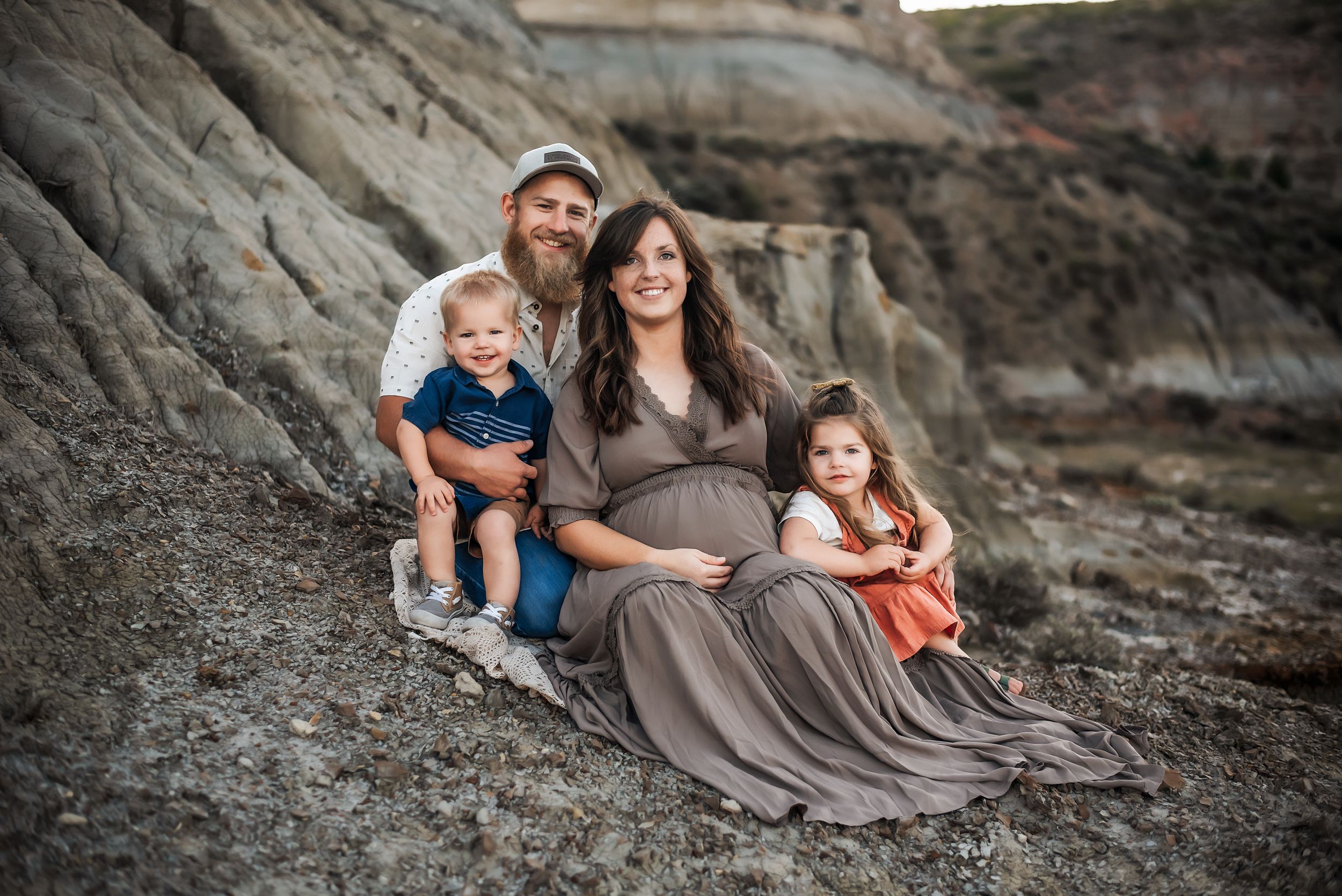 Expecting mother with two children and husband during family maternity session - relaxed, natural light photography in southwest ND
