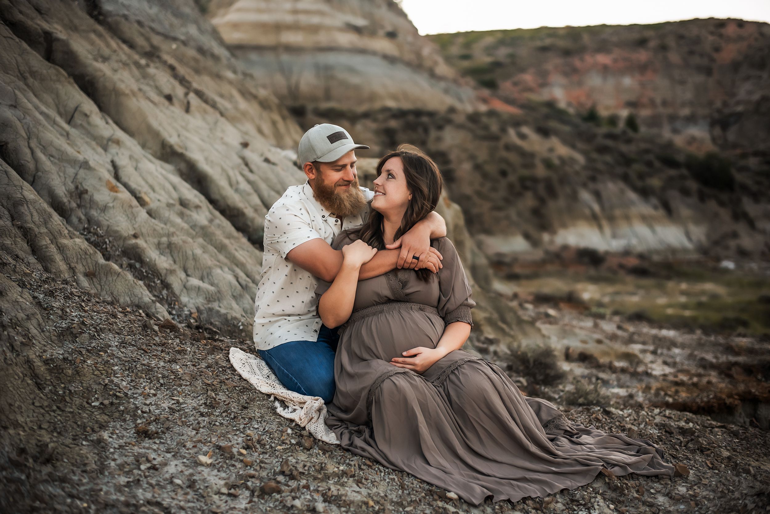 Mom and dad prepare for arrival of newborn baby in maternity session in the Badlands of North Dakota