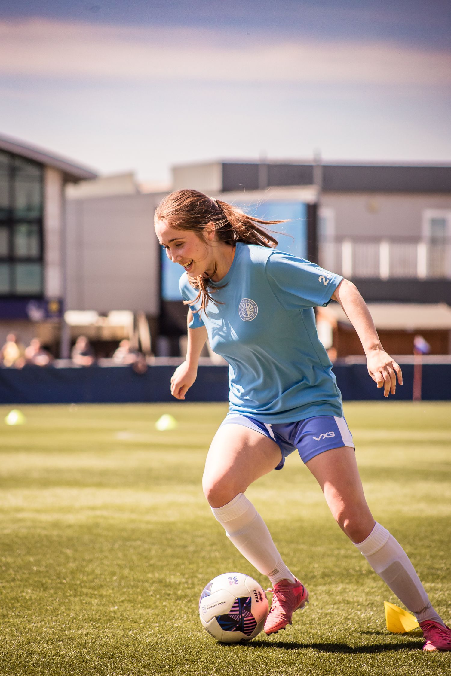 Female footballer warming up ahead of a game at Sixways Stadium in Worcester