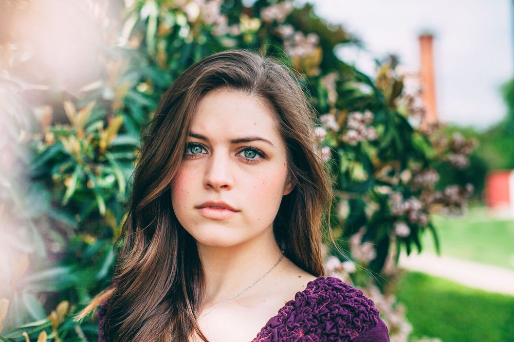 Portrait session in a garden setting with vibrant flowers and natural lighting.