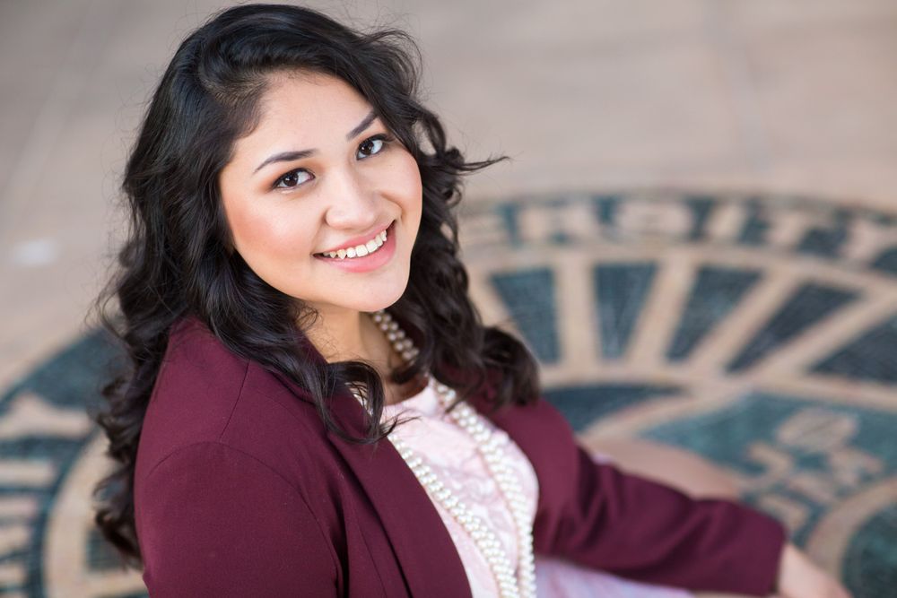 Professional portrait session showcasing elegant poses in a burgundy blazer against a neutral background.