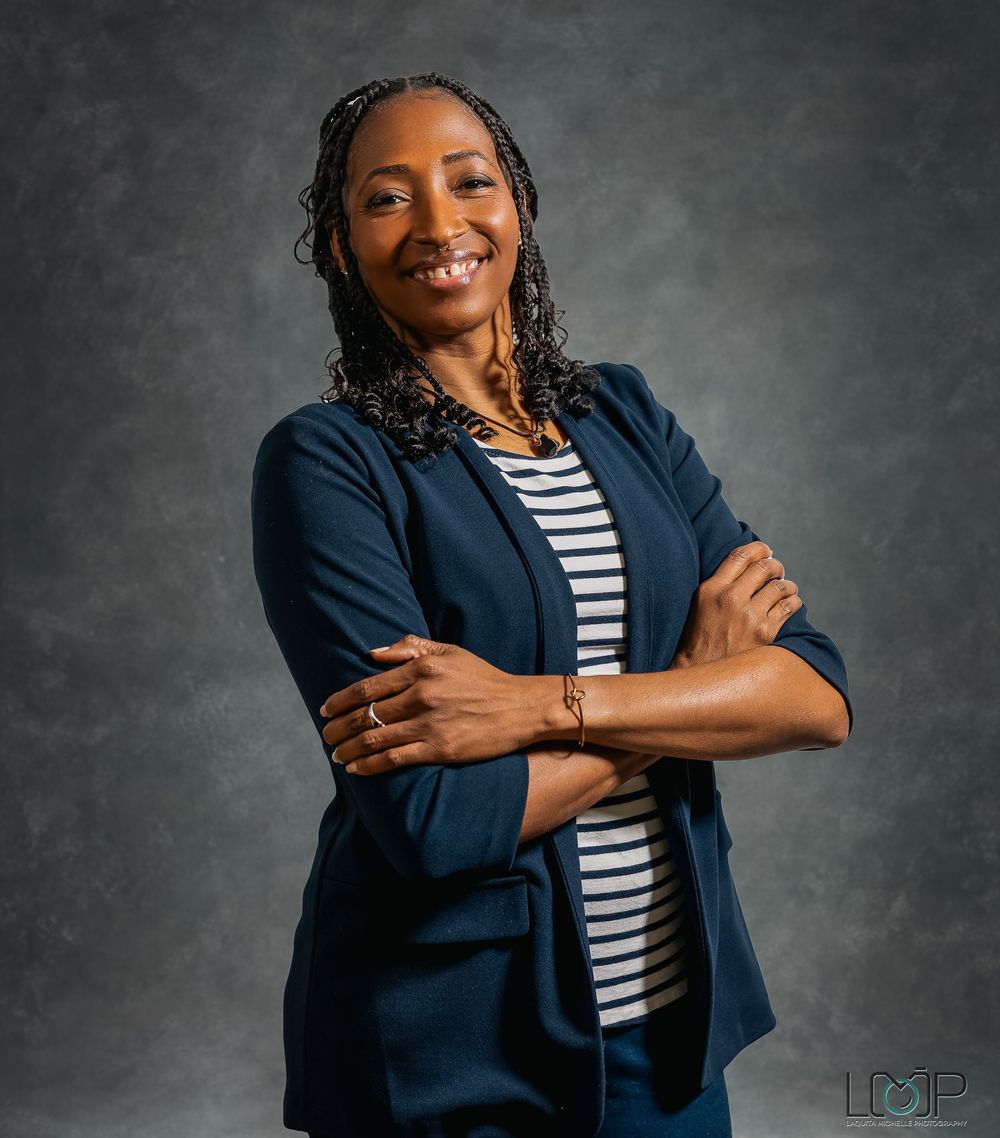 Professional studio photo series showing someone in a navy blazer and striped shirt making expressive poses against gray backdrop.