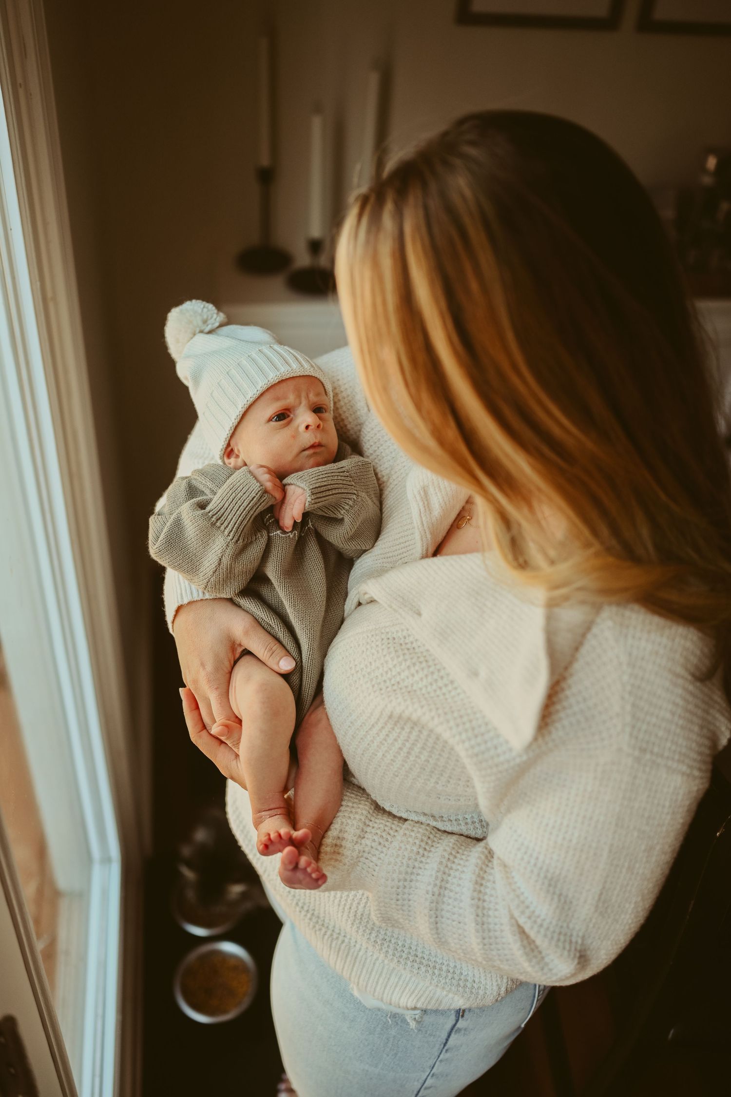 Baby boy looks up at mom during lifestyle newborn session in Clarksville, Tennessee by Disney Magic Photography