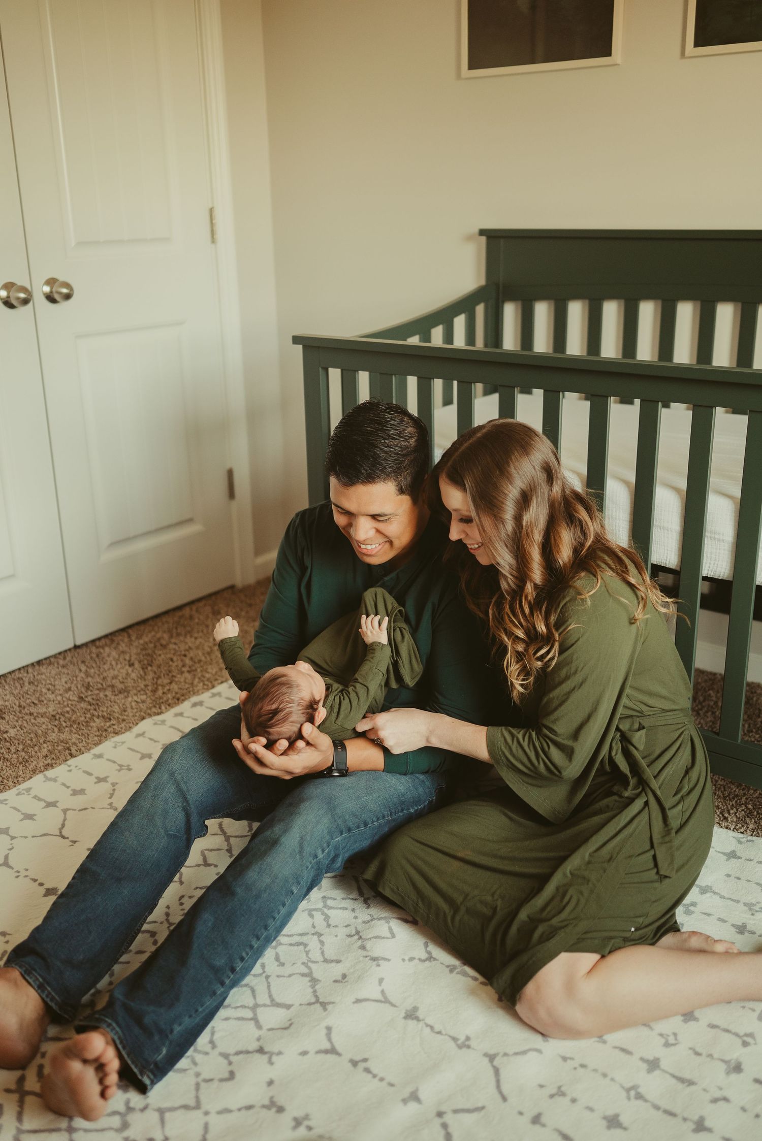 New parents admire baby in nursery during lifestyle newborn session in Clarksville, Tennessee by Disney Magic Photography