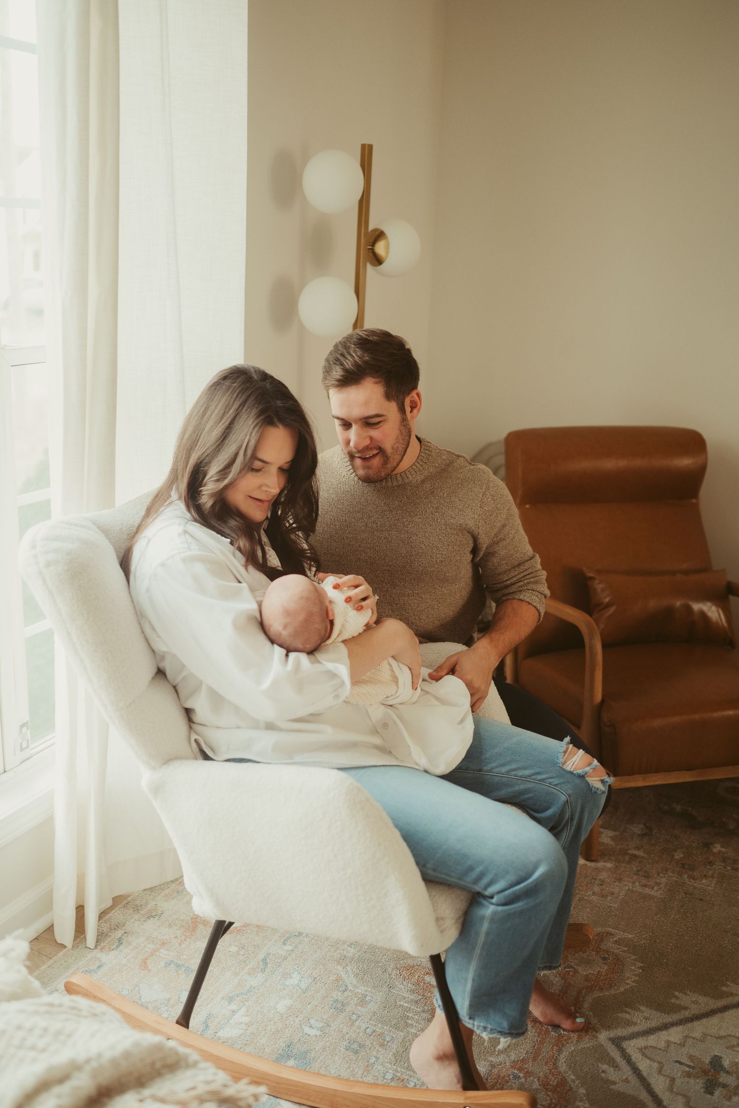 New mom and dad look at baby boy during lifestyle newborn session in Clarksville, Tennessee by Disney Magic Photography
