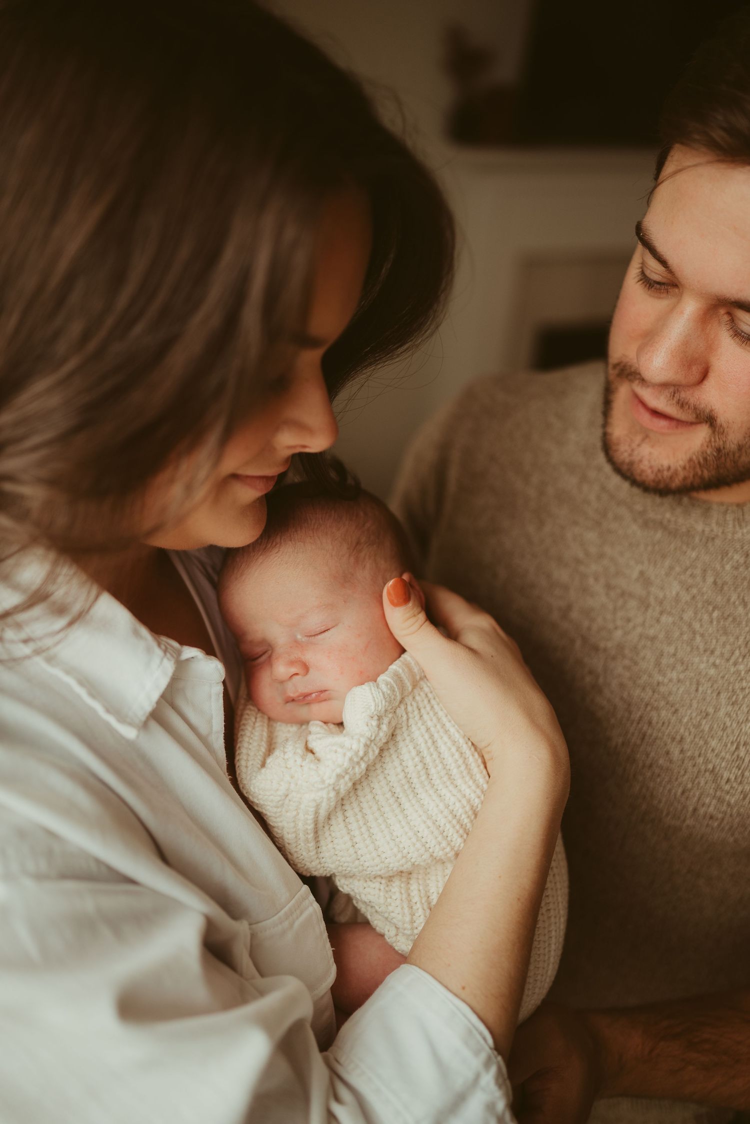 New mom and dad look at baby boy during lifestyle newborn session in Clarksville, Tennessee by Disney Magic Photography