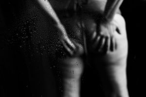 Artistic black and white photo with water droplets and dramatic shadows.