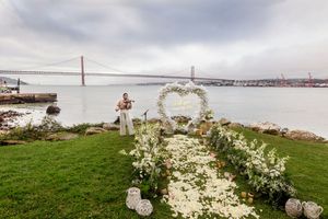 A romantic wedding ceremony setup on a grassy cliff overlooking the Golden Gate Bridge in San Francisco Bay.