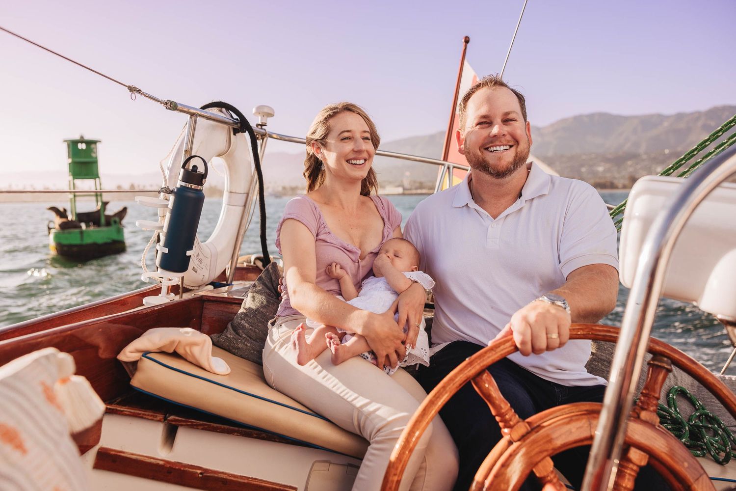 Couple enjoying a romantic boat ride along the coastline at sunset.