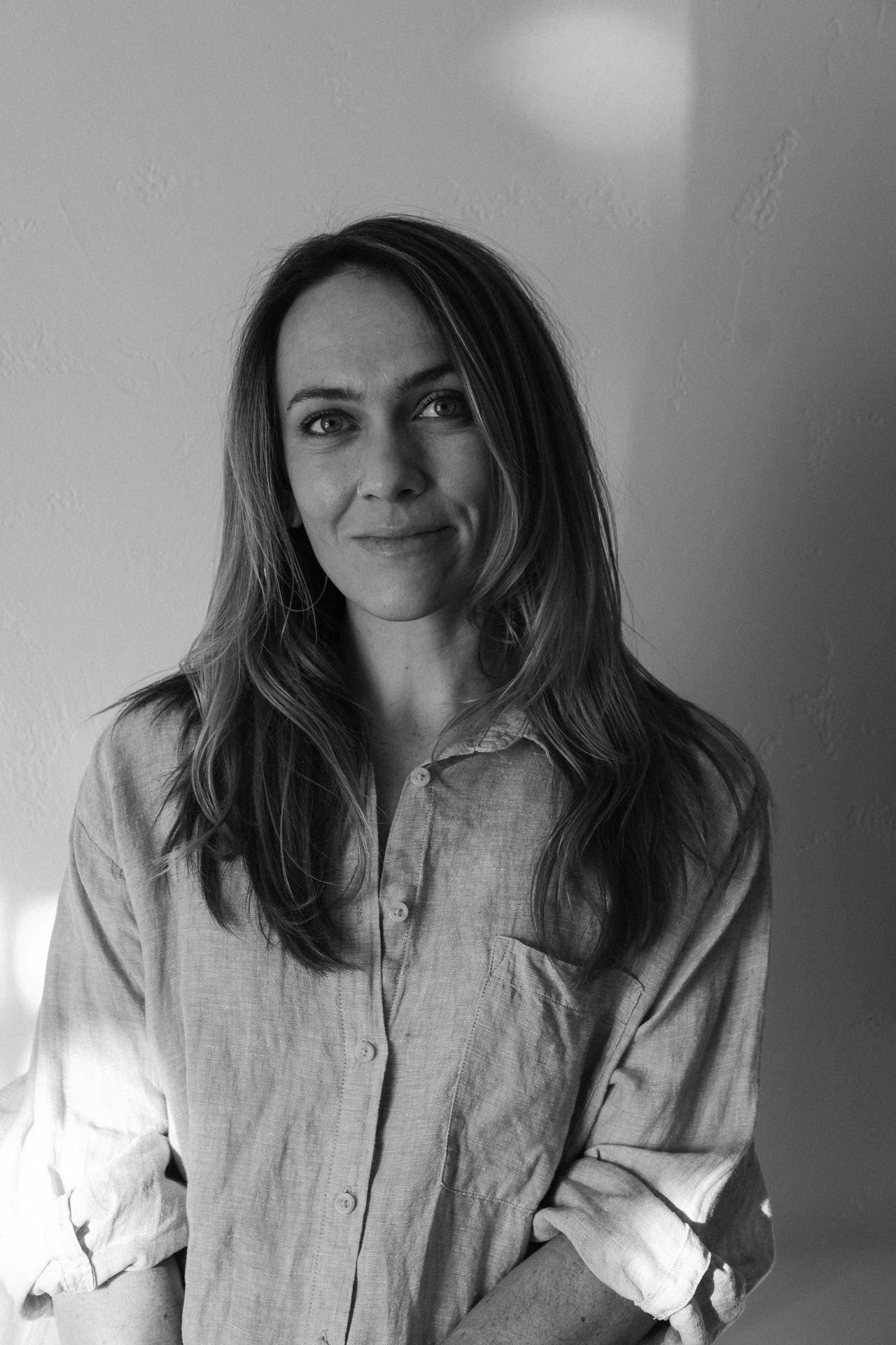 Portrait series showing person in orange sweater and beige cap against dark background.