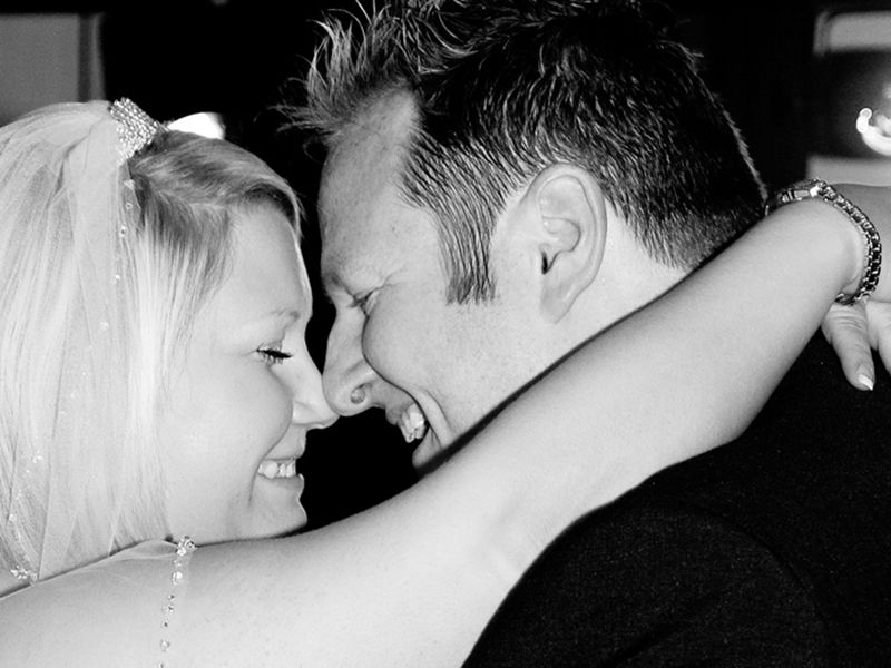 Black and white photograph of a bride and groom sharing their first dance, captured in High Wycombe by Abigail's Studio.