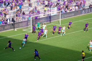 Soccer match action sequence showing players competing near the goal.