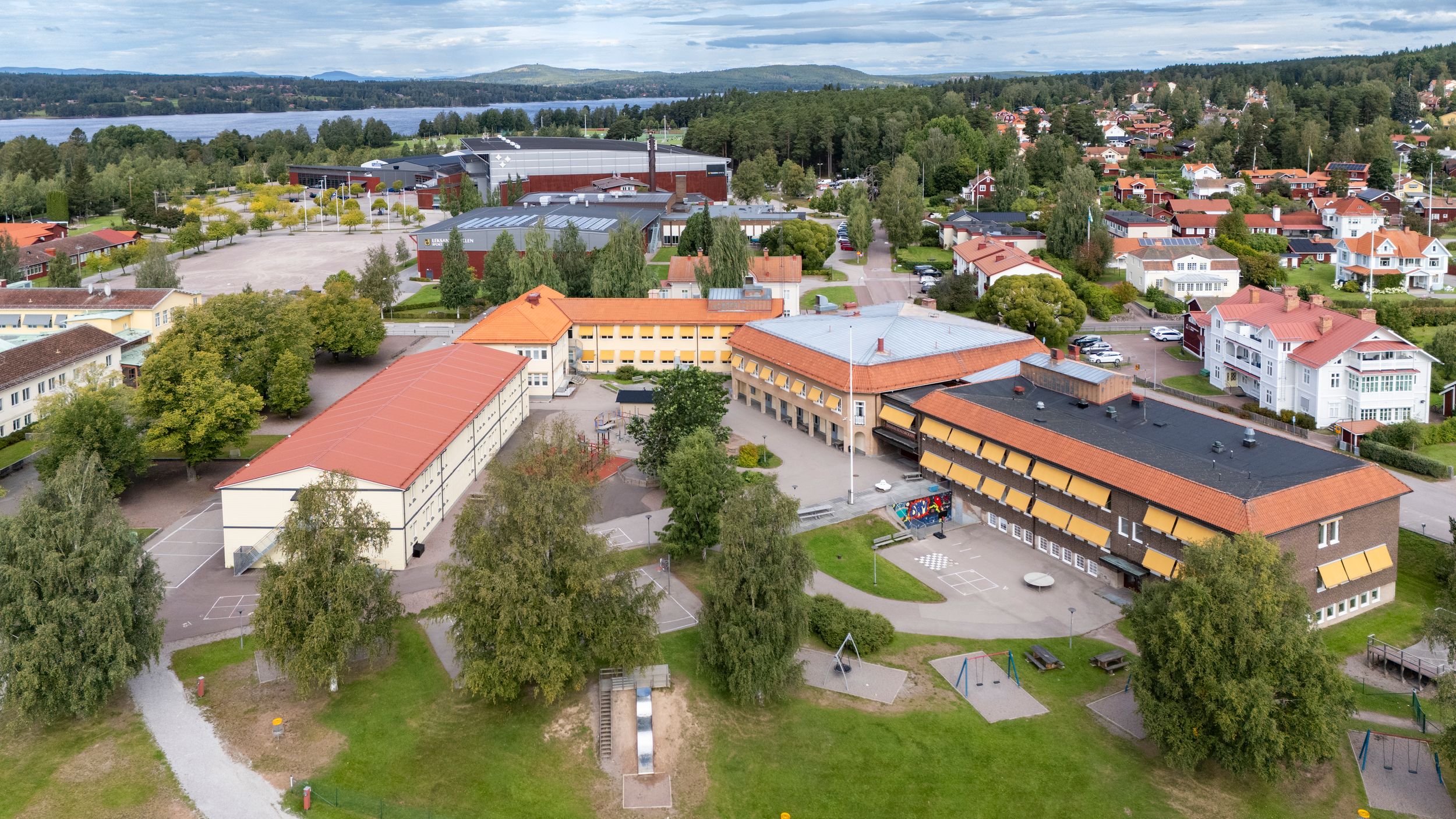 Panoramic aerial view of a suburban neighborhood with buildings and trees.