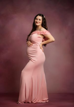 Maternity photo series showing a pregnant woman in a pink dress against a dark burgundy background.