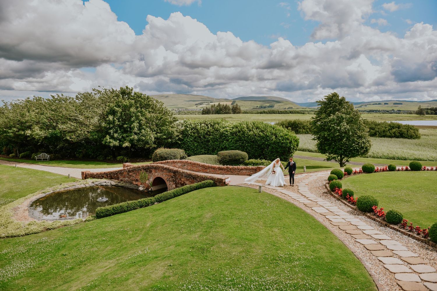 Bride and Groom holding hands in Gardens at Western House Hotel in Ayr.