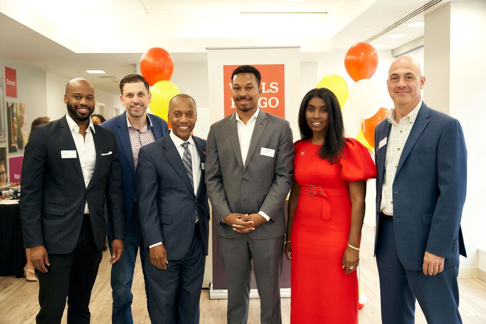 A group of business professionals gathered at a Wells Fargo corporate event.