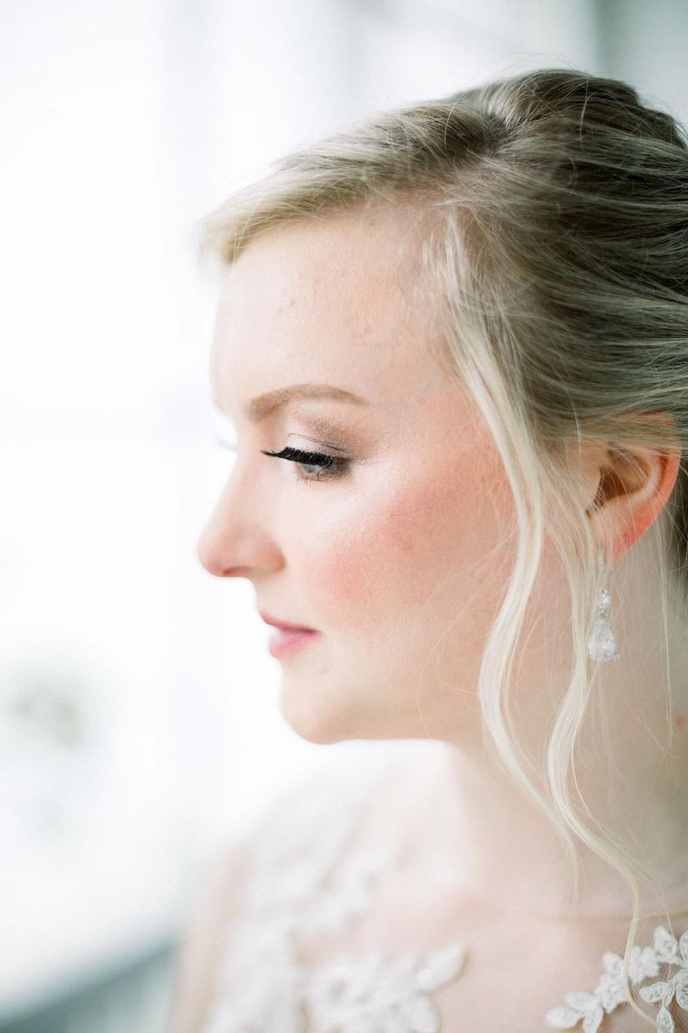 Close-up bridal beauty portrait featuring soft glam makeup, radiant skin, and wedding elegance.