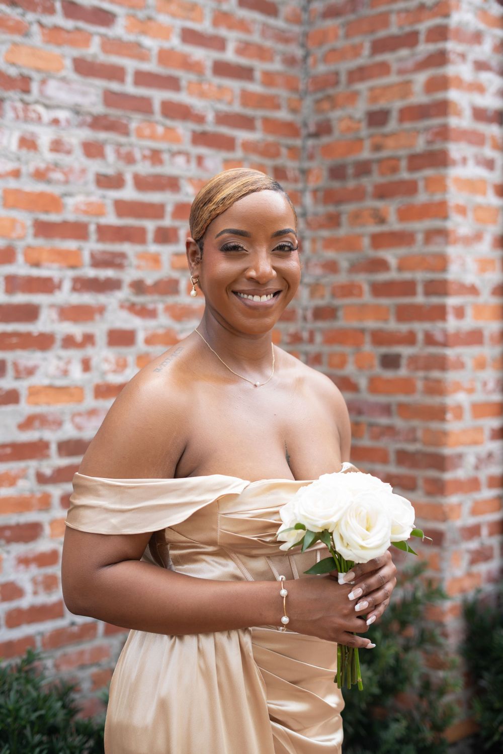 Bridesmaid portrait featuring soft glam makeup, radiant skin, and wedding-ready beauty styling.