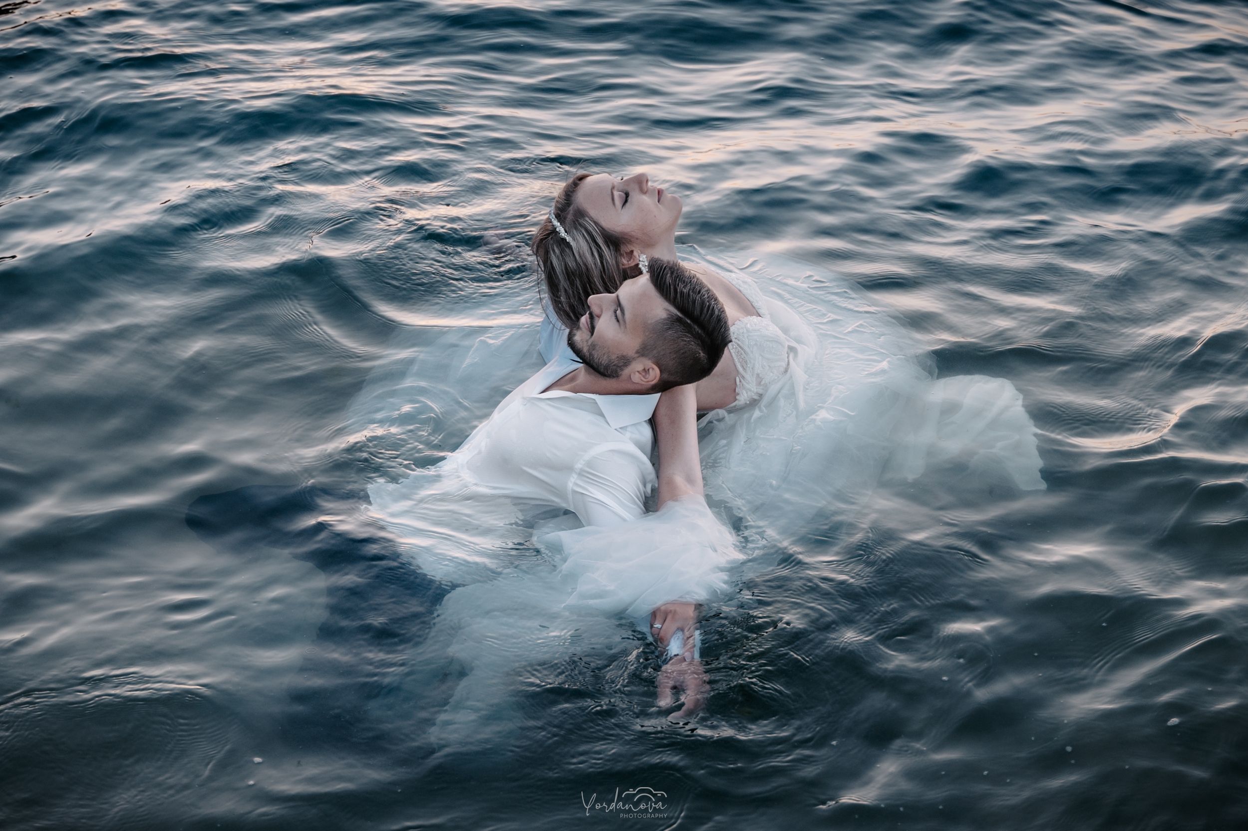 An artistic underwater photography session in deep blue ocean waters.