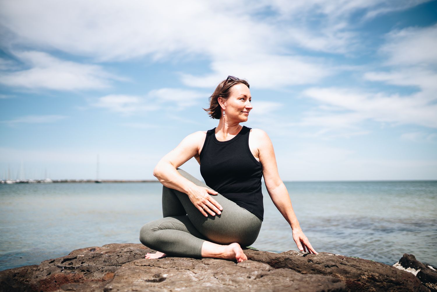 Yoga and qigong instructor doing stretches in an outdoor beach professional branding photo session with a Melbourne branding Photographer