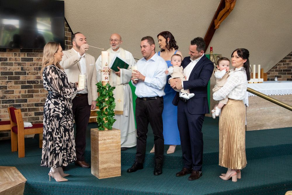 baby boy getting christened with mother holding him