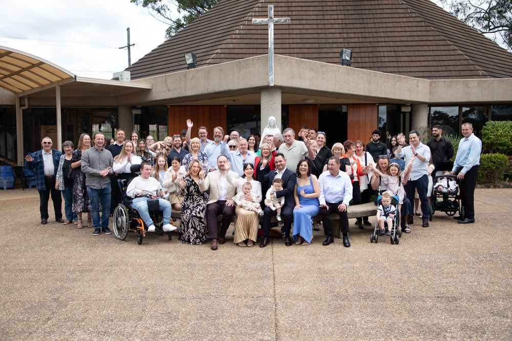 group photo baby boy getting christened with mother holding him