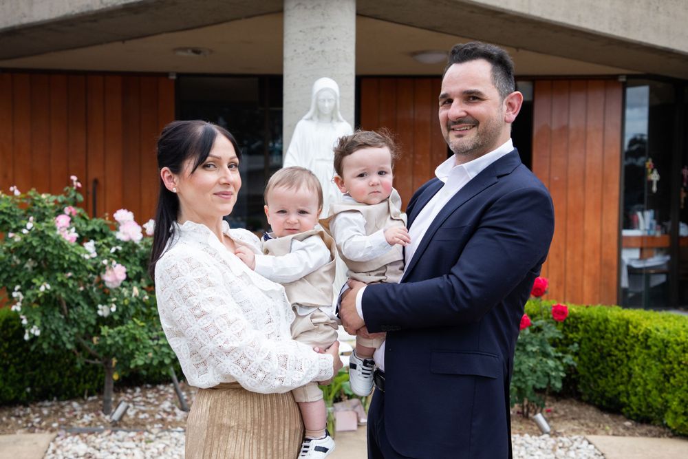 baby boy getting christened with mother holding him