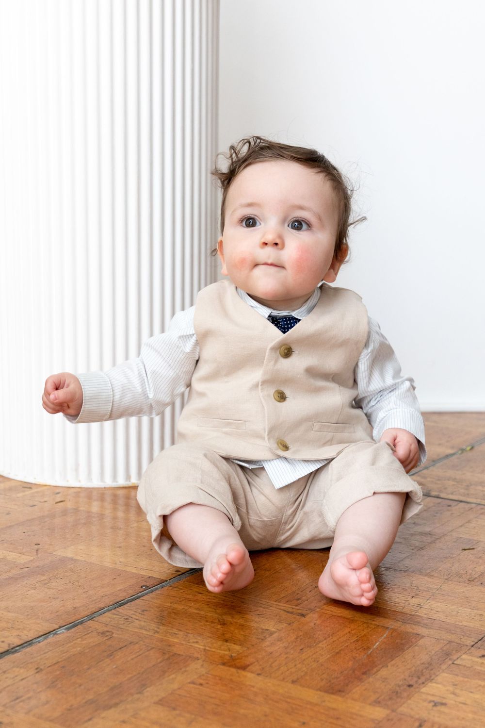 baby boy getting christened with mother holding him