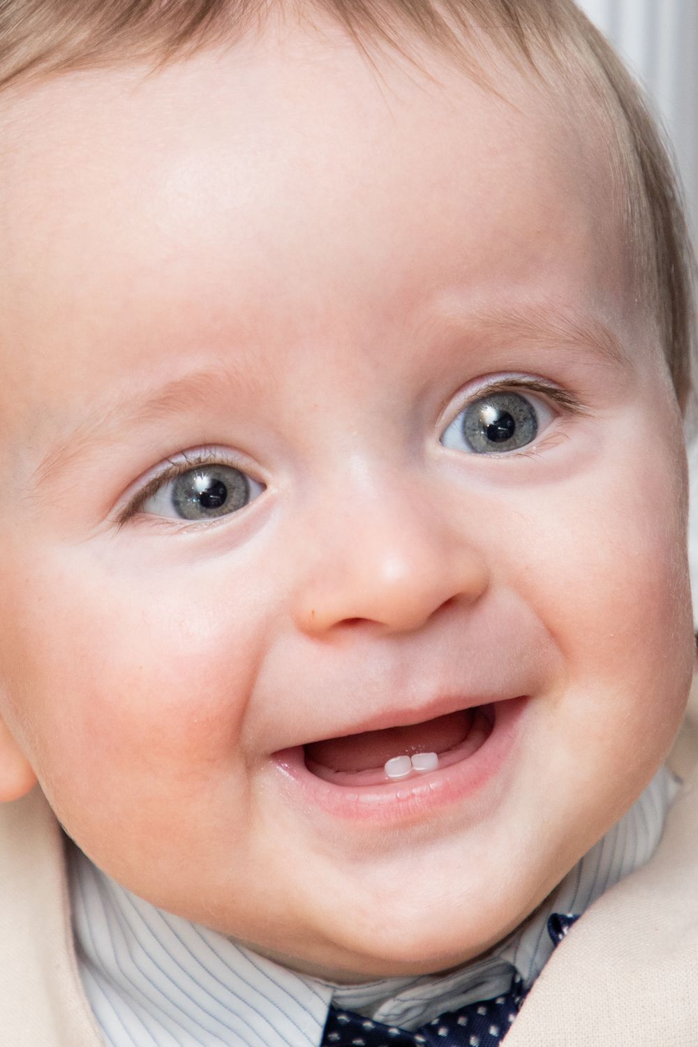 baby boy getting christened with mother holding him