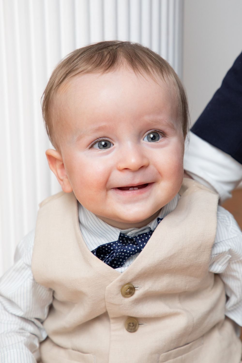 baby boy getting christened with mother holding him