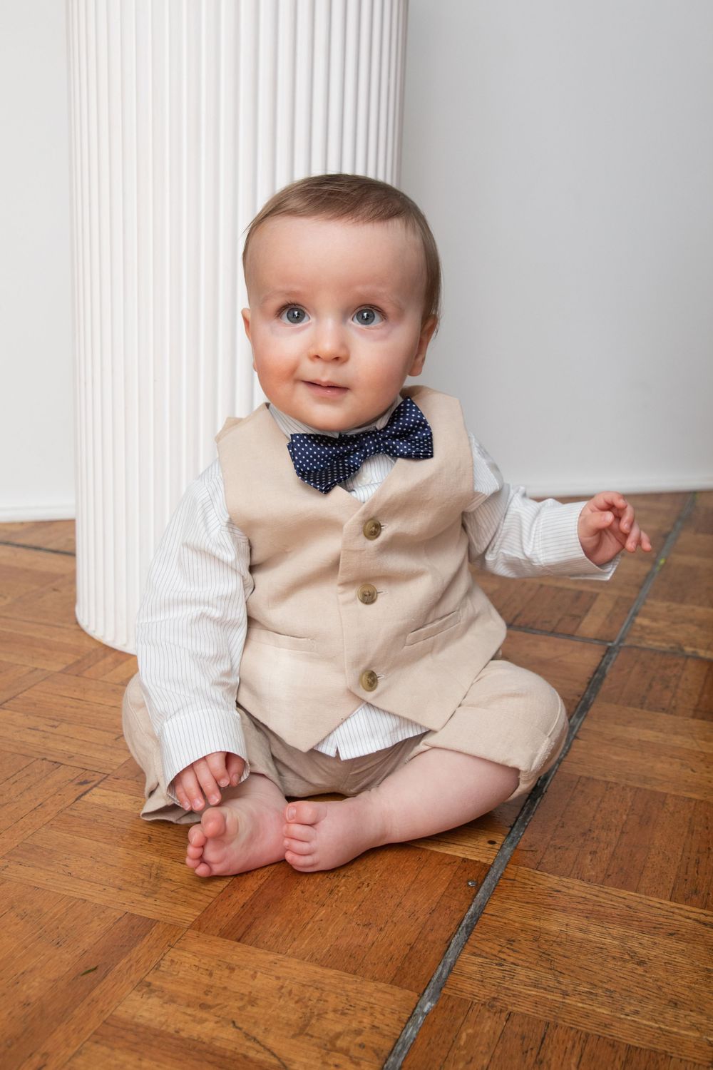 baby boy getting christened with mother holding him