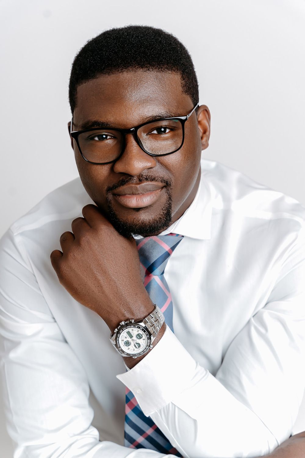Crisp headshot of a man in white shirt and multicoloured tie in Winnipeg