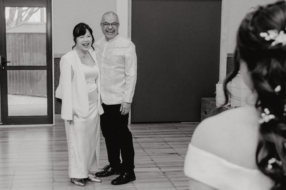 Black and white wedding photo showing couple in formal attire.