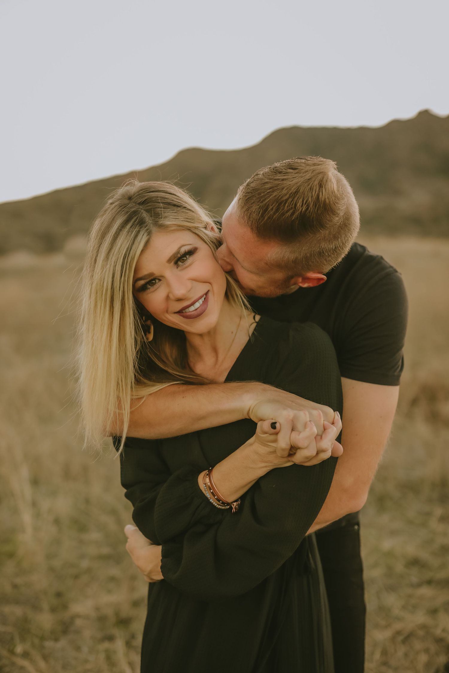 woman and man hugging in a field