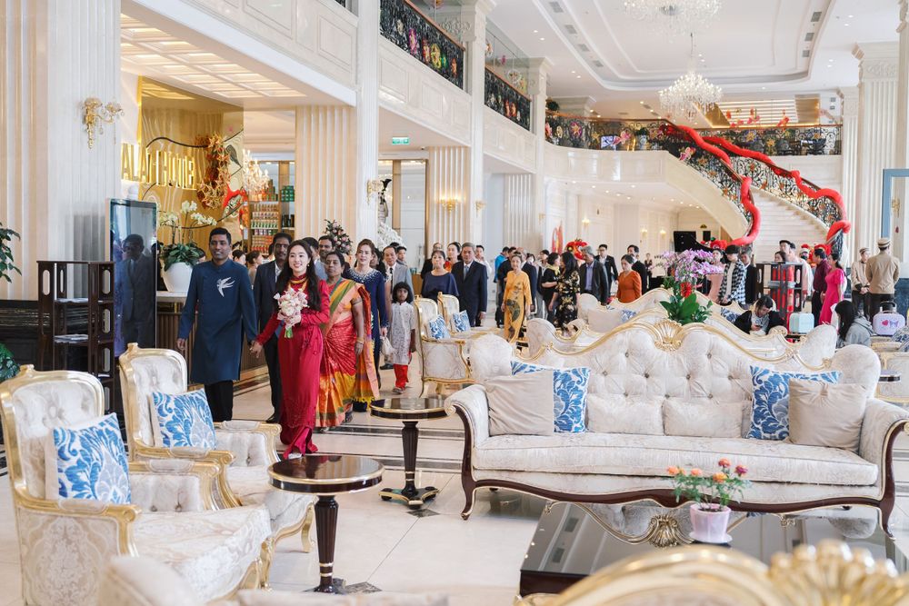 Luxurious hotel lobby reception area with elegant furniture and mingling guests.