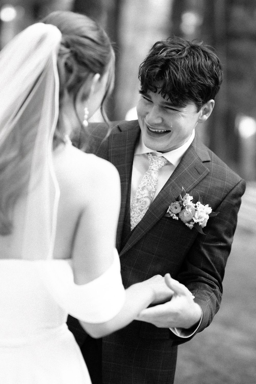 A black and white wedding photo series showing a couple dancing and embracing in formal attire.