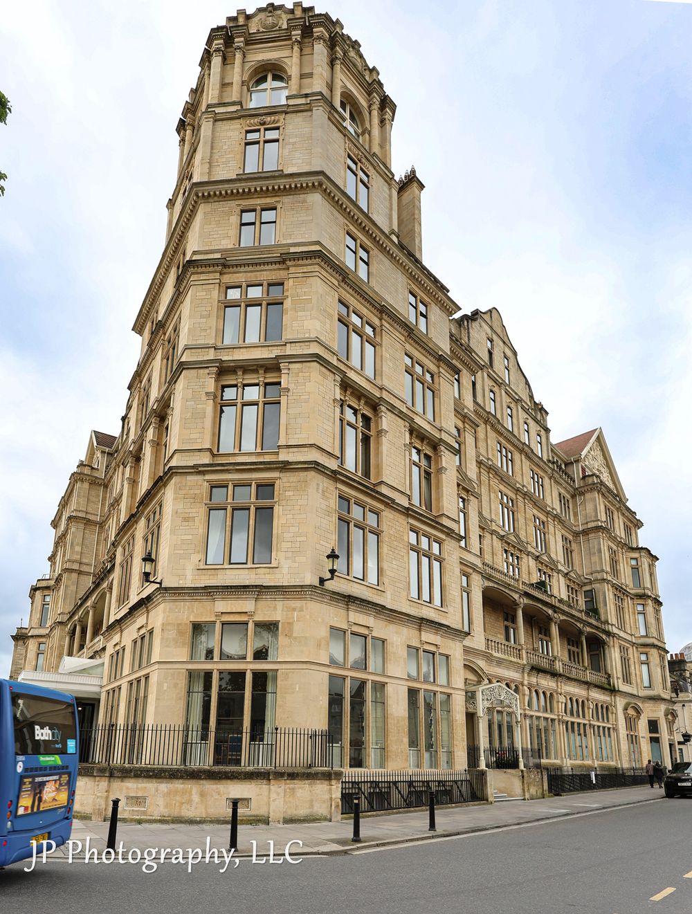 Victorian-style stone building with multiple windows and architectural details shot from street level.
