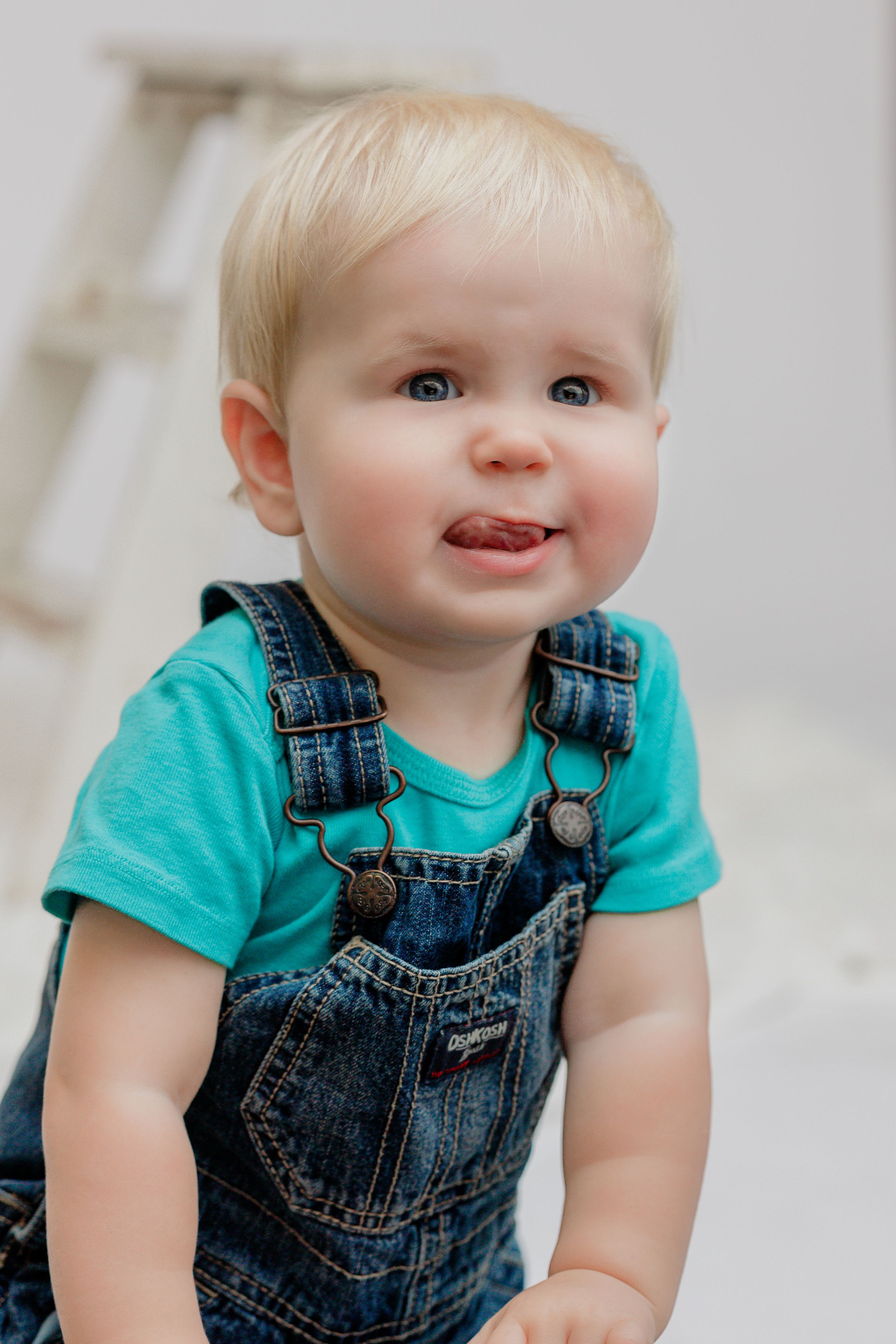 Smiling toddler sticking out tongue