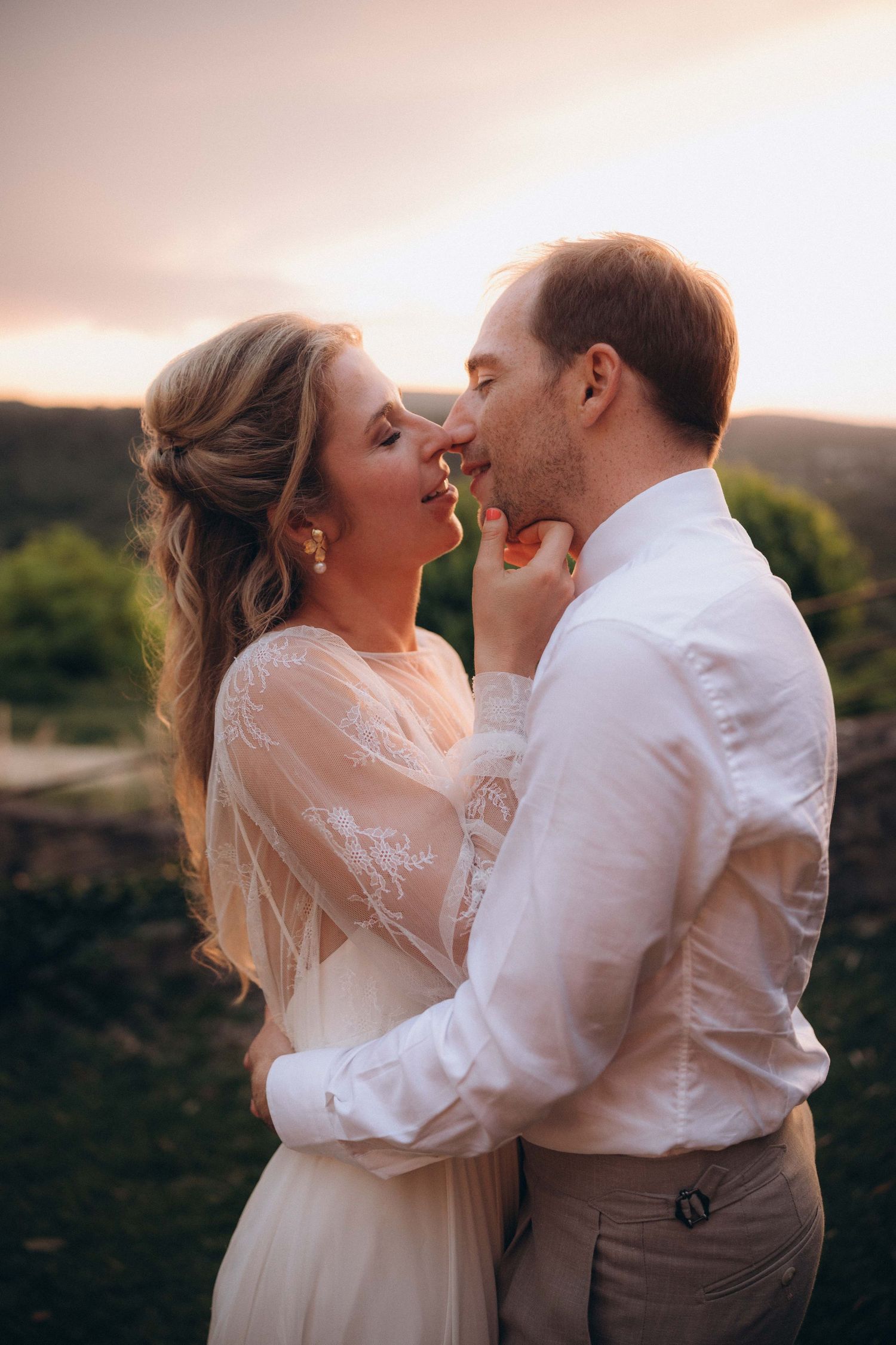 A tender autumn embrace captured during a wedding photoshoot with fall foliage.