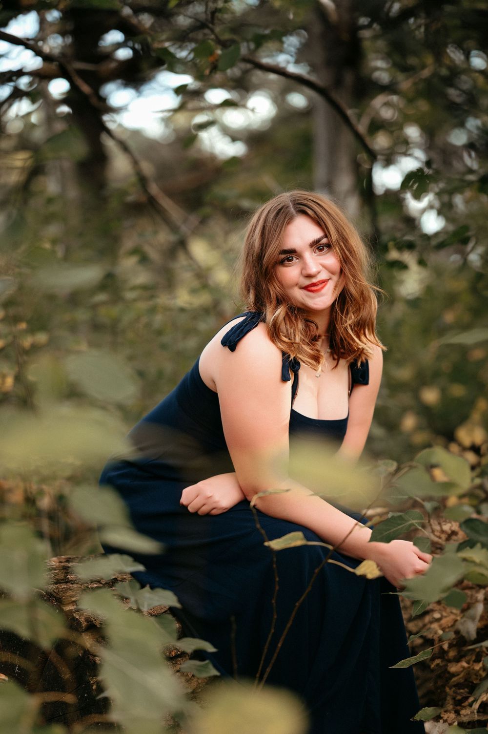 Senior photos in Brookings SD with lush green backgrounds, warm edits and timeless portrait styling.