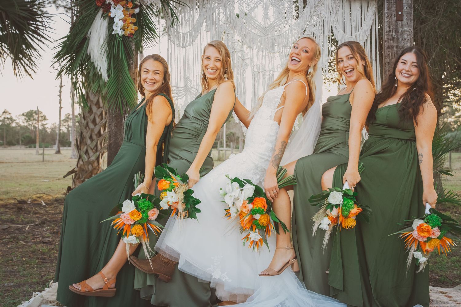 A bride shows off her cowgirl boots alongside her bridesmaids in a coastal cowgirl themed wedding