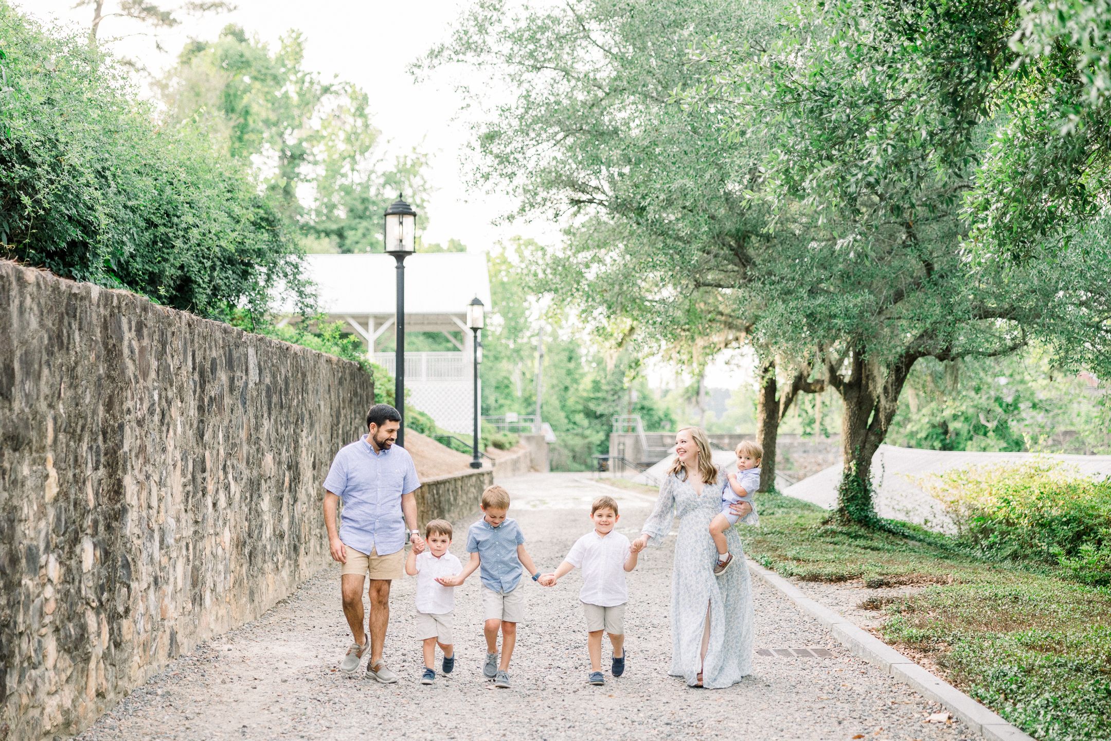 Family walking together during outdoor family session at Savannah Rapids in Augusta GA