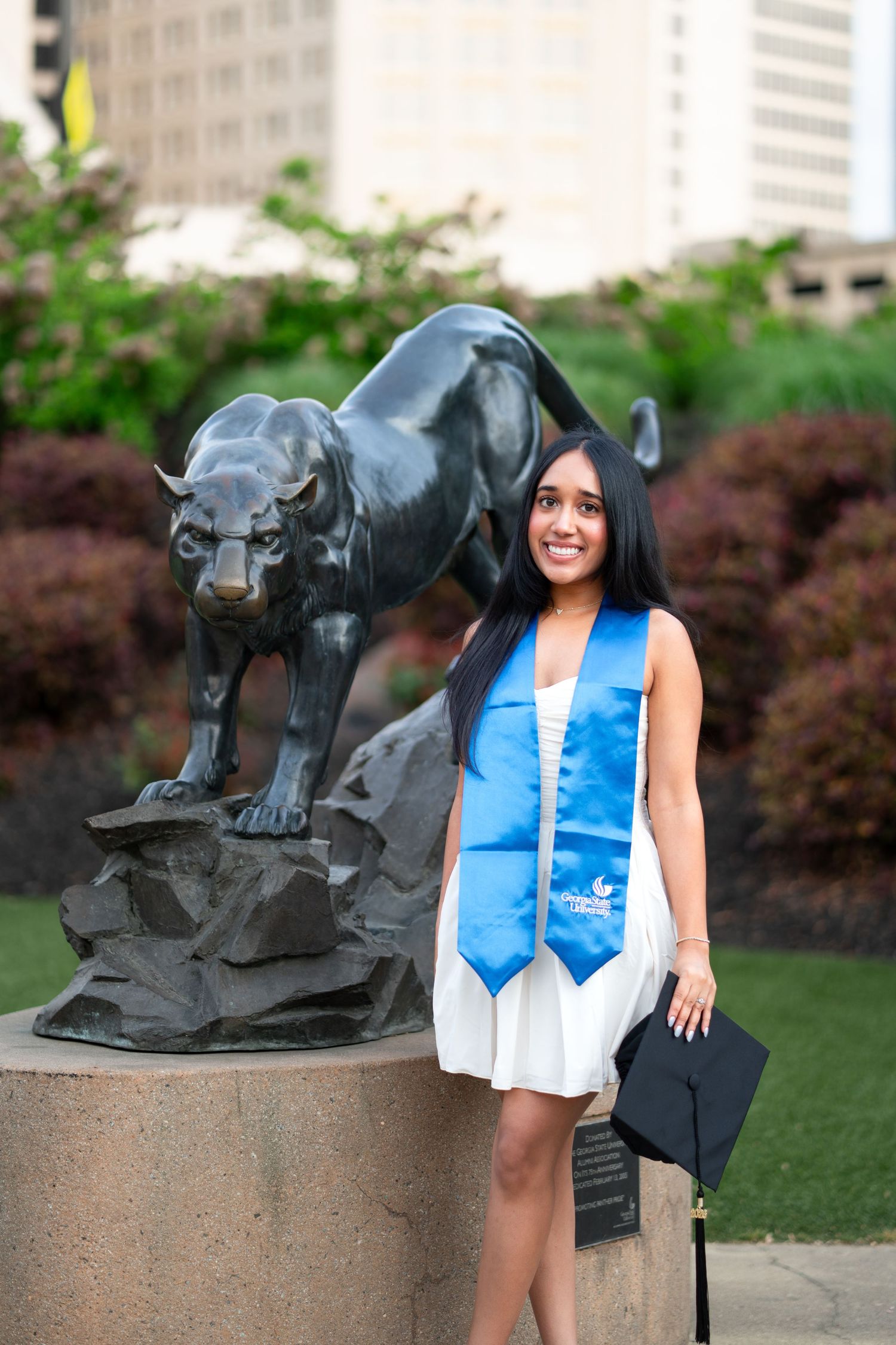 Smiling graduate poses for the best Atlanta grad photos at Georgia State University GSU with portraits by Pierre The Pear Photography