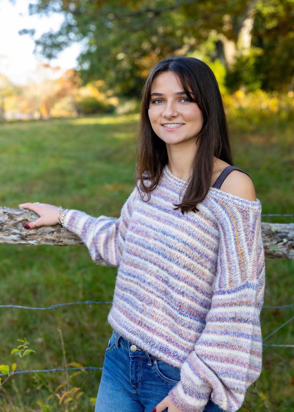 A Lincoln Sudbury Senior poses in a grassy field in Weston, MA for yearbook portrait session. High School senior photographer. Wayland.