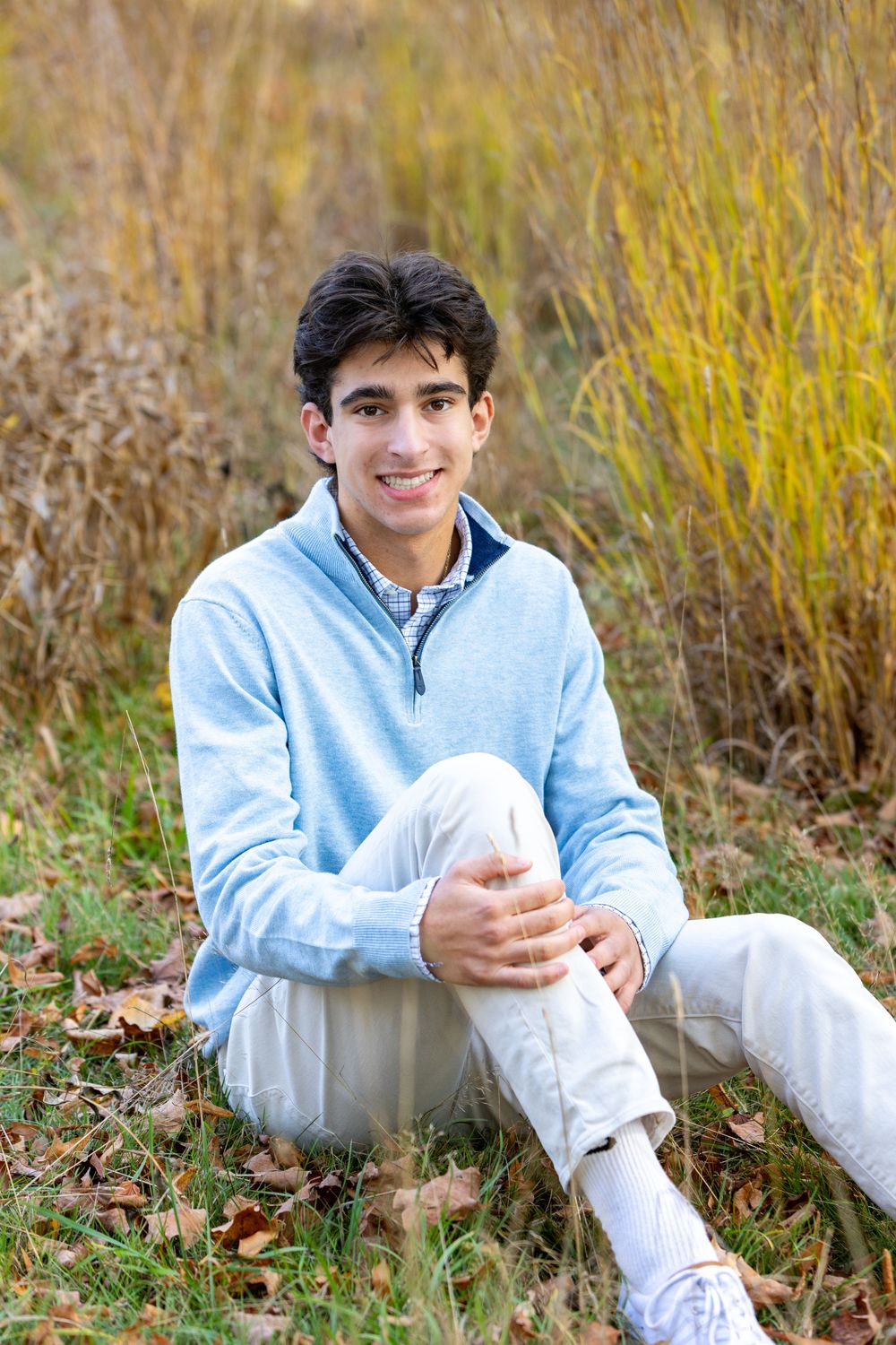 High school senior in a meadow by North Bridge Concord, MA for yearbook portrait session at sunset golden hour. High School photos