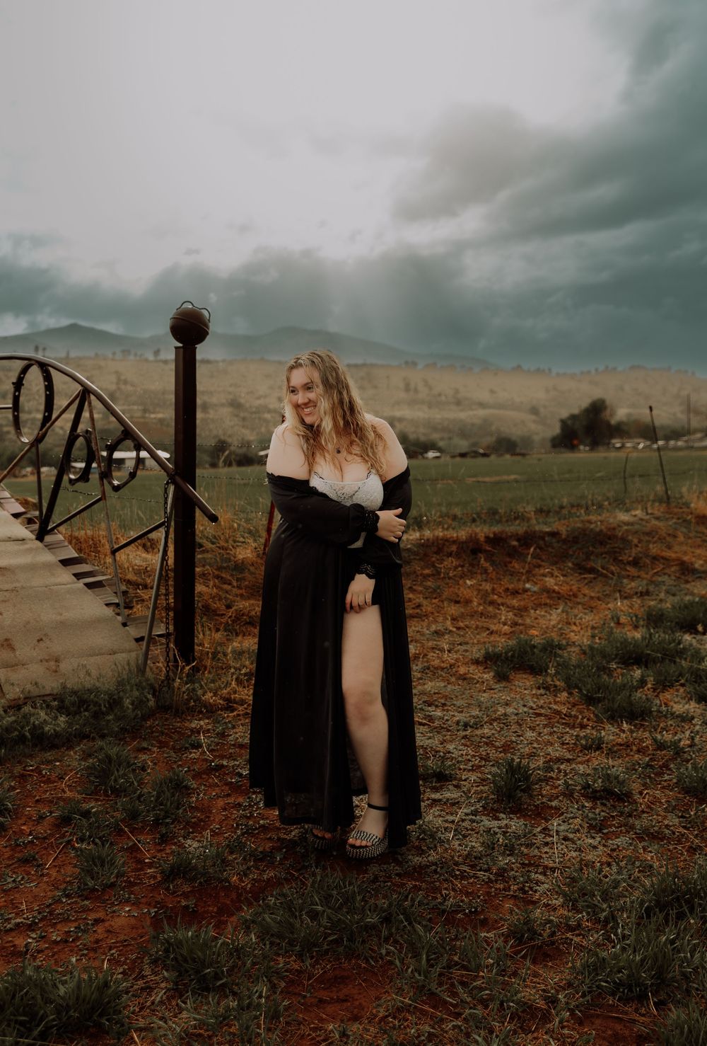 Woman stands and poses in field for dramatic, cinematic, portrait, and modeling photos in Fort Collins, Colorado