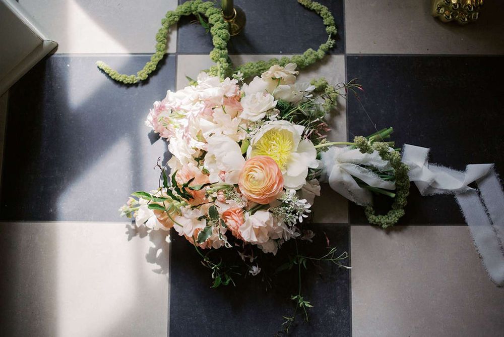 Estate Washington Wedding styled shoot - floral bouquet tossed casually on a black and white checkered floor