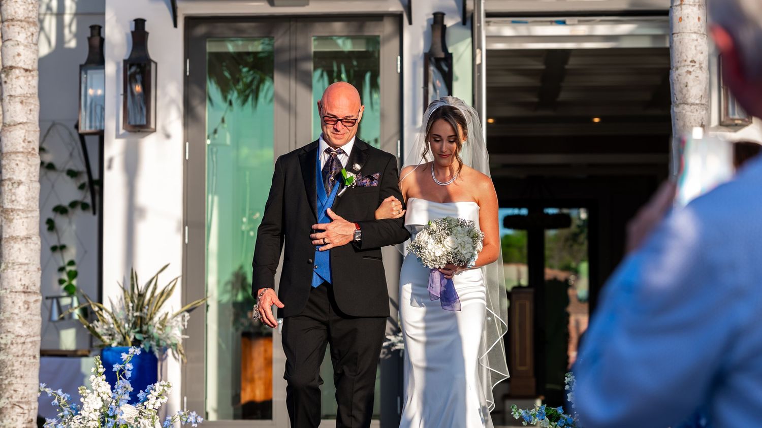 The father walks his daughter down the aisle during sunset at this beautiful estate wedding on the Treasure Coast.